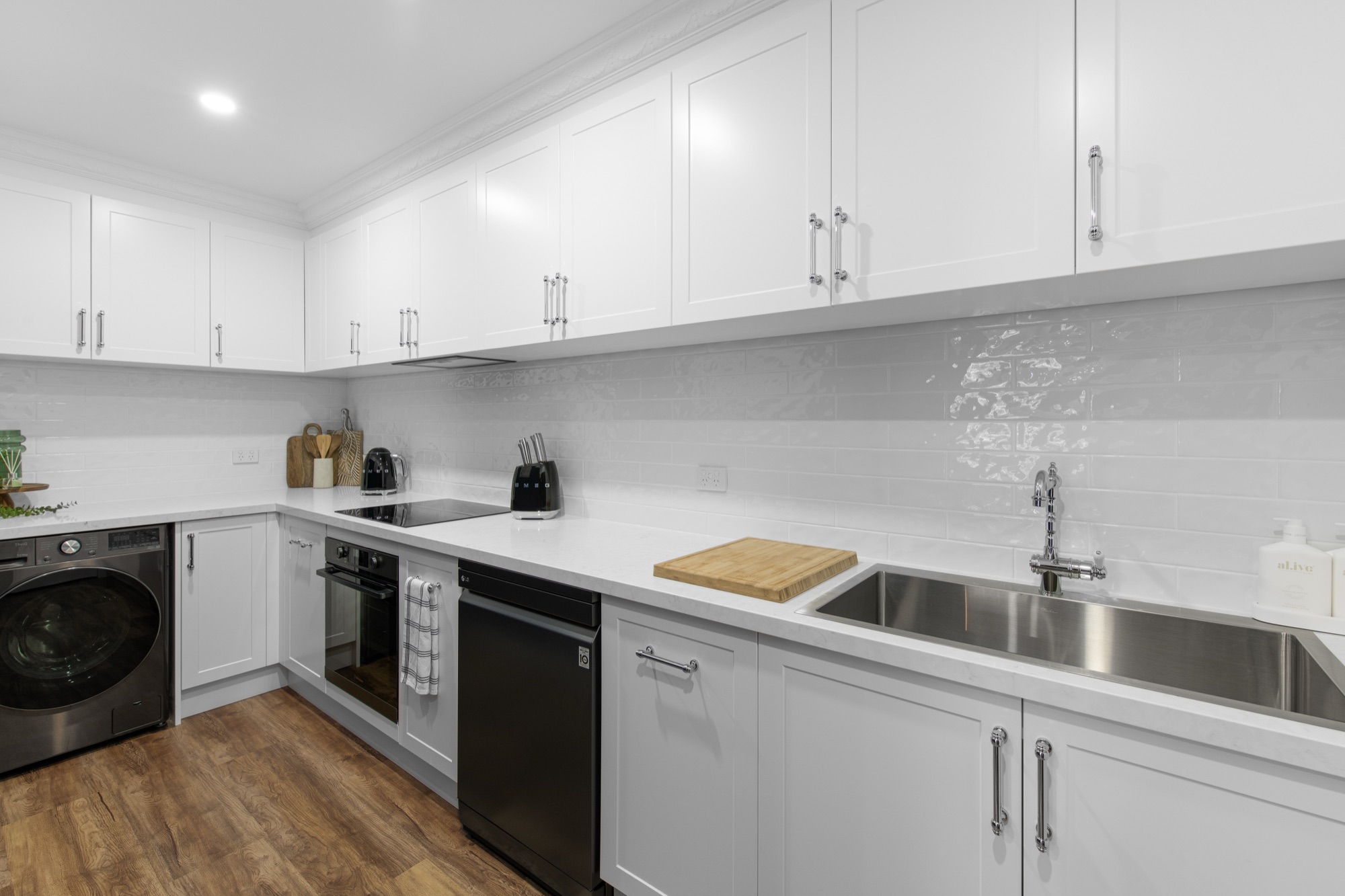 A modern Australian-made kitchen with custom cabinetry and stone benchtop