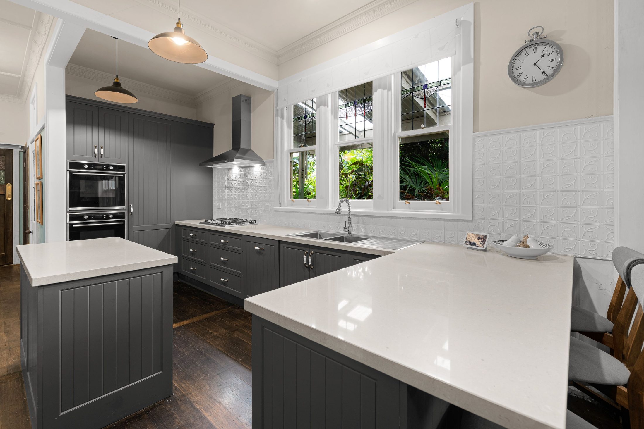 Kitchens U Build kitchen with a white stone bench top and charcoal cabinetry