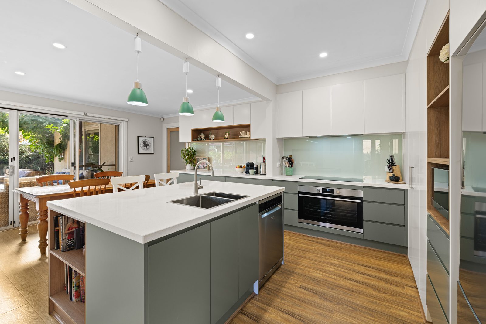 Kitchens U Build project with a white stone bench top and sage green cabinetry