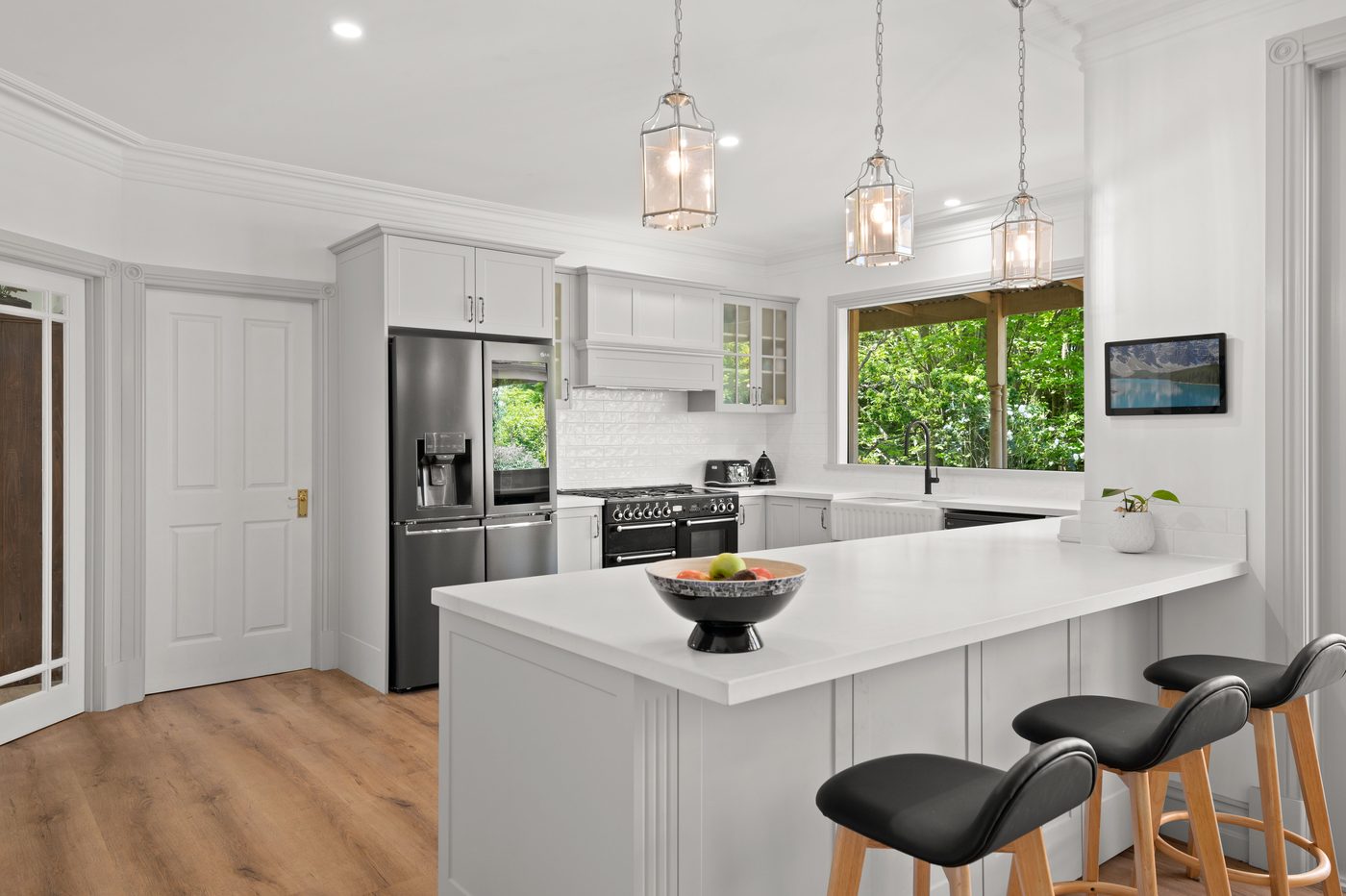 White stone island bench in a classic white kitchen